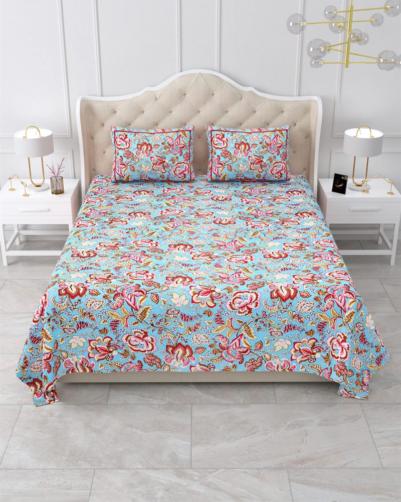 Aqua and red Jacobean floral bedsheet in a refreshed bedroom