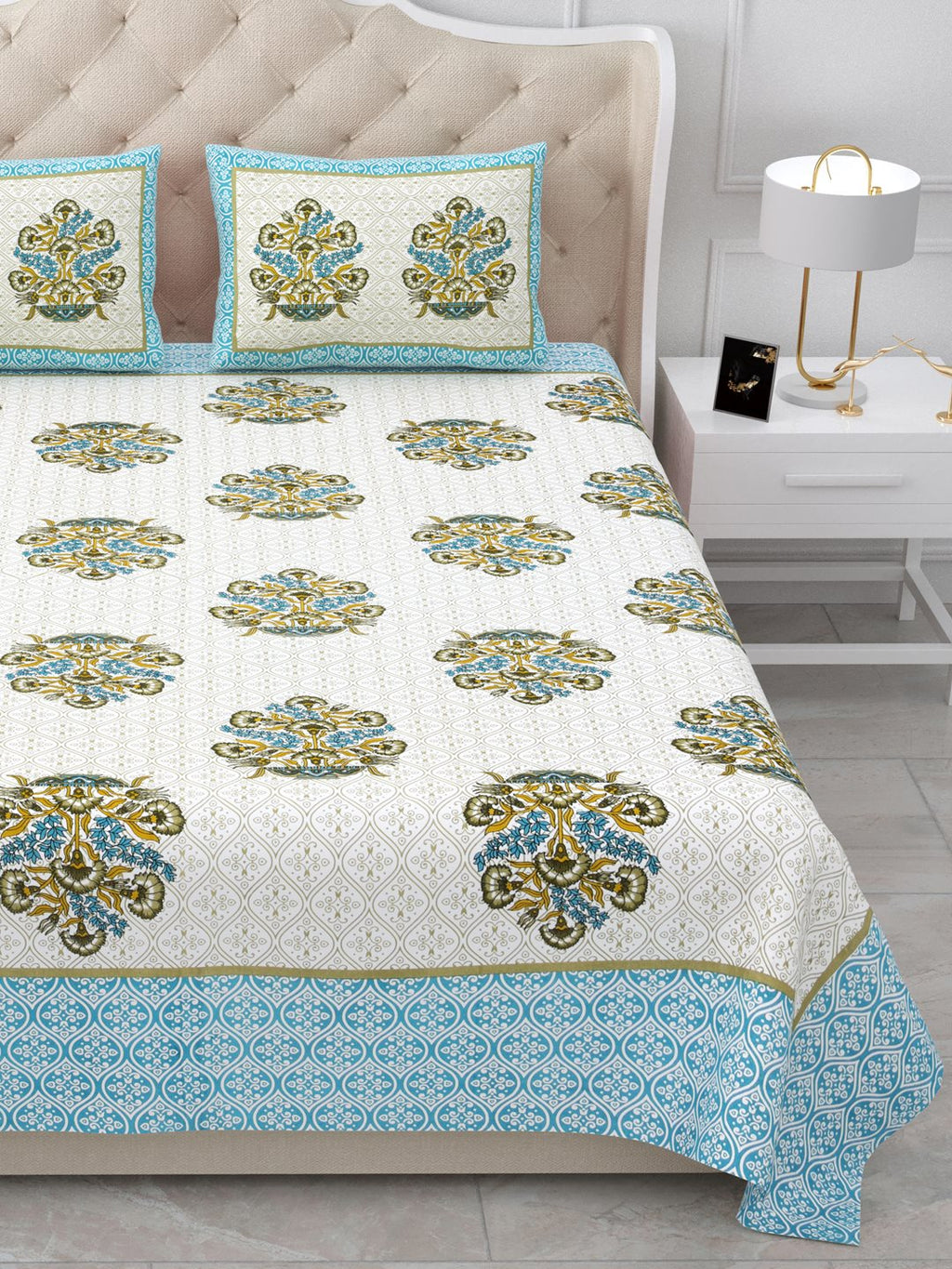 Close view of the bed showing rows of bouquet butas and the aqua-blue patterned border
