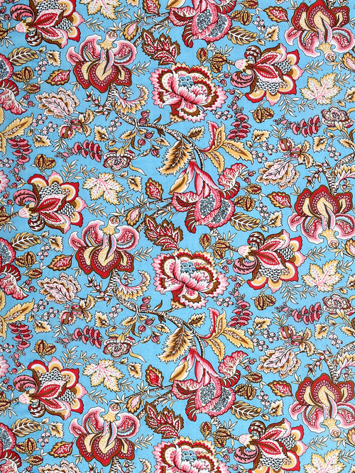 Close-up of large red, pink and mustard Jacobean-style flowers on an aqua sky-blue base