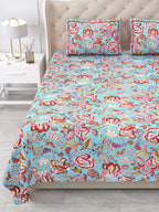 Close view of the aqua and red floral bedsheet and pillow covers on the bed