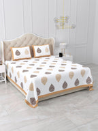 Angled view of the beige & brown damask buta bedsheet on a bed with 2 pillow covers
