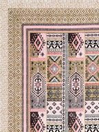 Corner close-up of blush pink, mauve, dark brown and black kilim-style panels and the sand beige geometric border