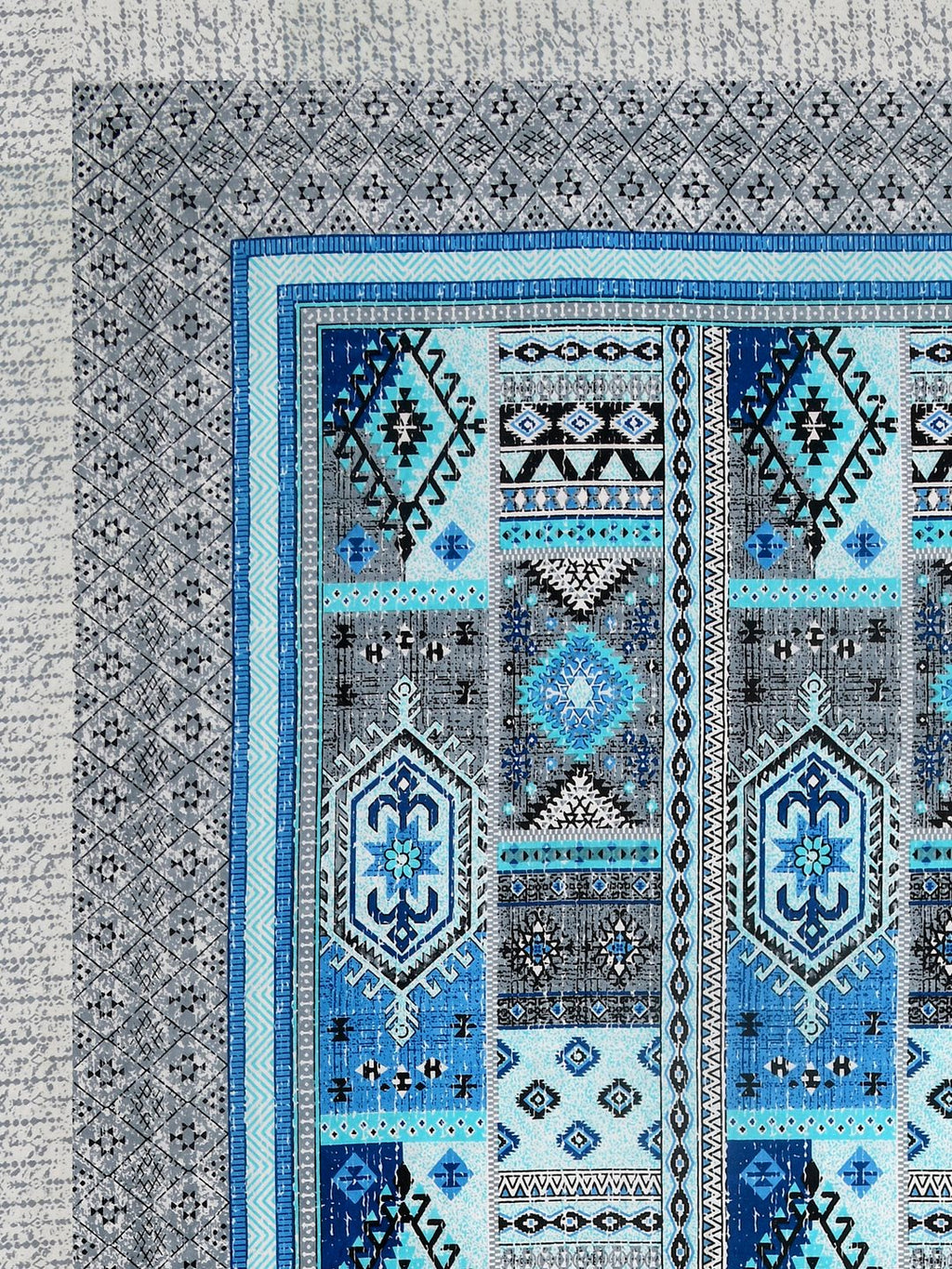 Corner close-up of sky blue, royal blue, aqua and black kilim-style panels and the grey geometric border