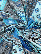 Swirled fabric close-up of blue & grey Aztec and kilim-style geometric print