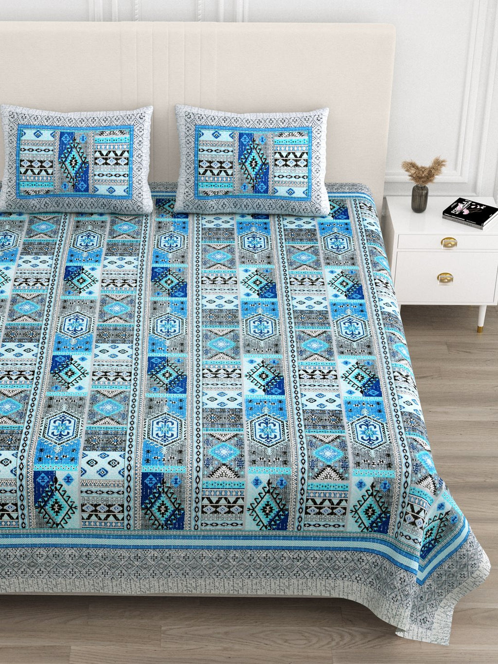 Close front view of the blue & grey geometric patchwork bedsheet and pillow covers