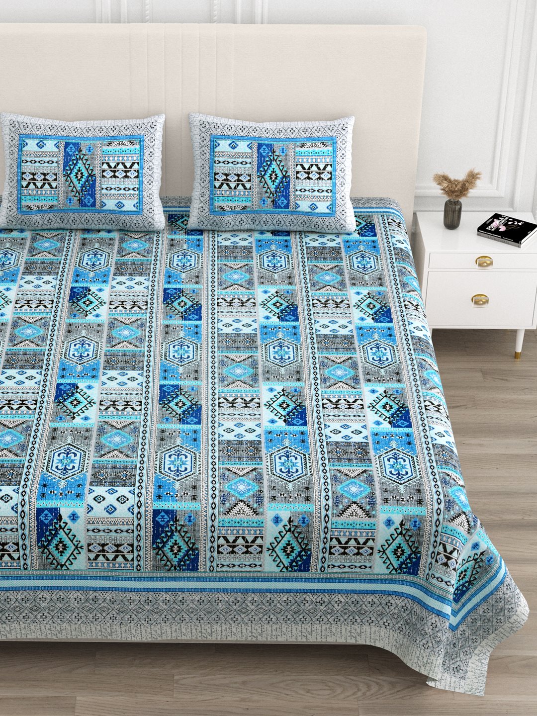 Close front view of the blue & grey geometric patchwork bedsheet and pillow covers