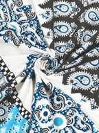 Swirled fabric close-up of navy, sky blue and charcoal paisley print on white