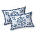Two white pillow covers with a blue mandala medallion and blue and beige chevron motifs