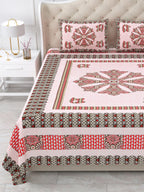 Close view of the pink mandala centre panel and brown and red borders on the bed