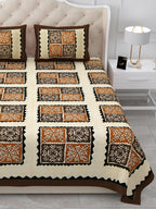 Close view of dark brown and rust-orange square blocks with black zigzag frames on the bed