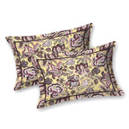 Two butter yellow pillow covers with plum and pink Jacobean florals and a thin dark border line