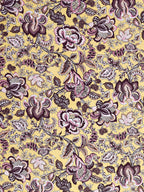 Close-up of large plum, rose pink and grey Jacobean-style flowers on a butter-yellow base