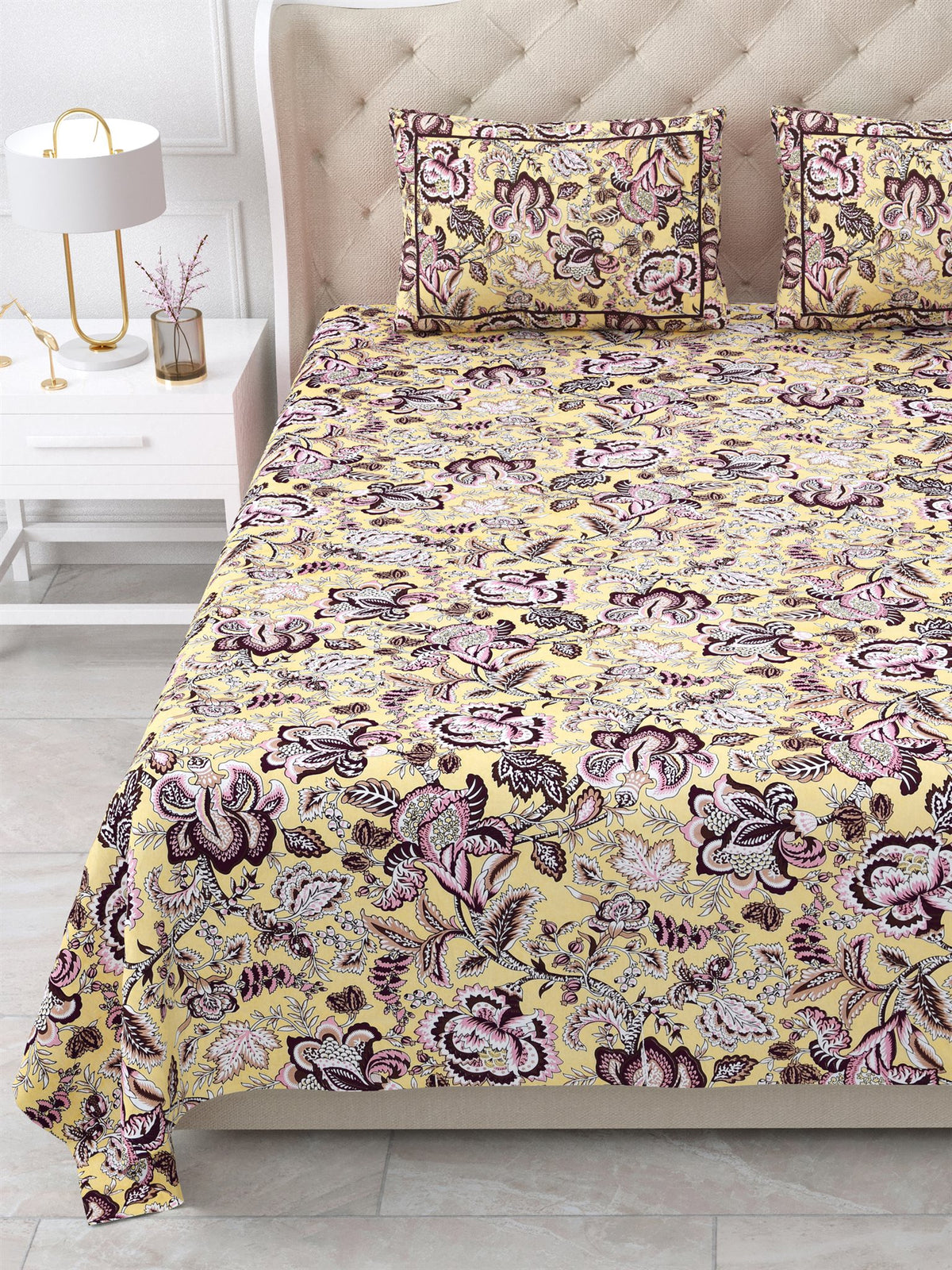 Close view of the butter yellow floral bedsheet and pillow covers on the bed