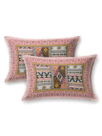 Two pillow covers with a coral pink geometric border and coral & mustard Aztec patchwork centre
