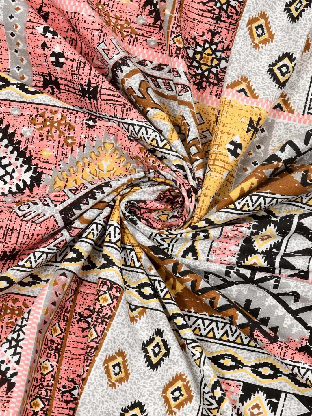 Swirled fabric close-up of coral & mustard Aztec and kilim-style geometric print
