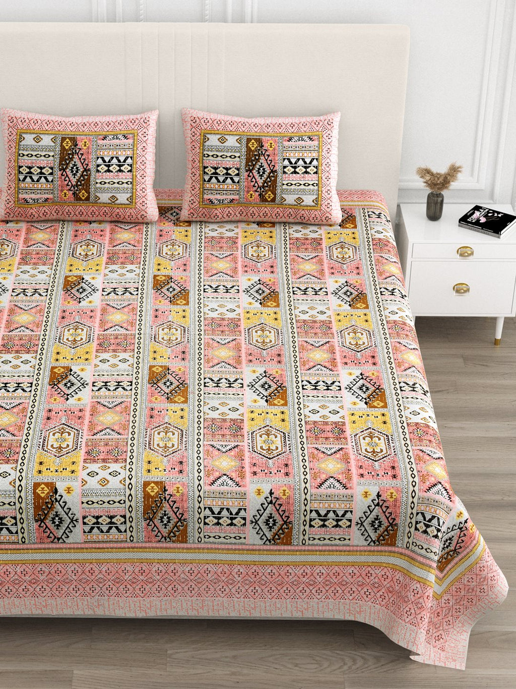 Close front view of the coral & mustard geometric patchwork bedsheet and pillow covers