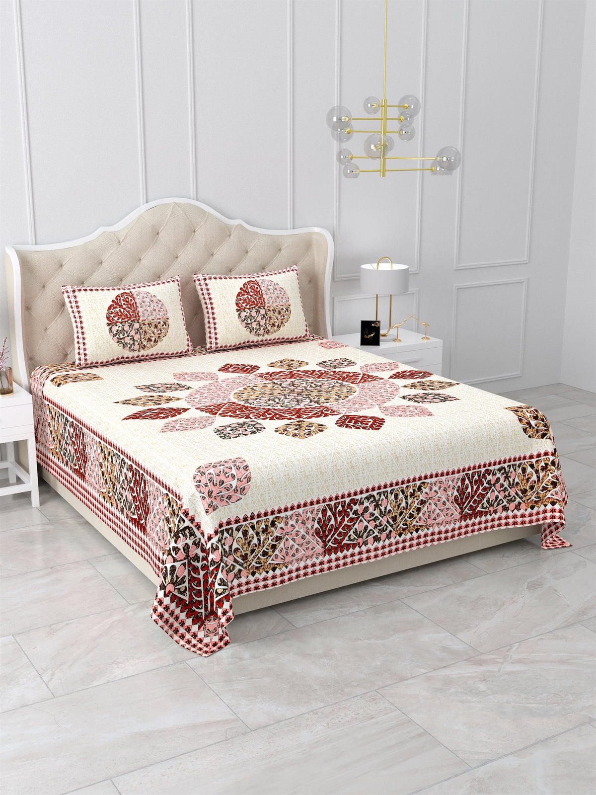 Angled view of the cream leaf mandala bedsheet showing the maroon leaf-motif side border