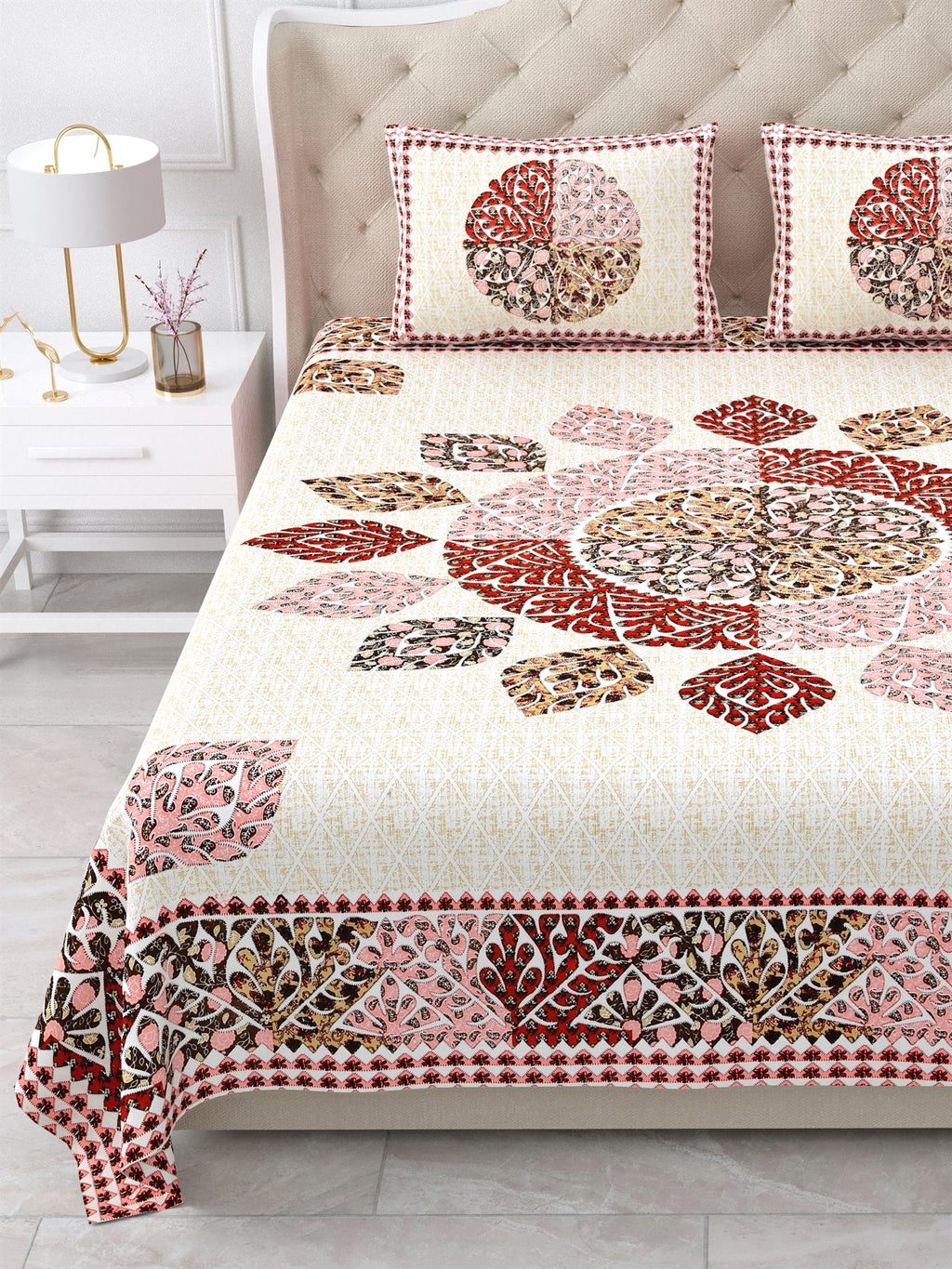 Close view of the maroon, rust and pink leaf mandala and border on the bed