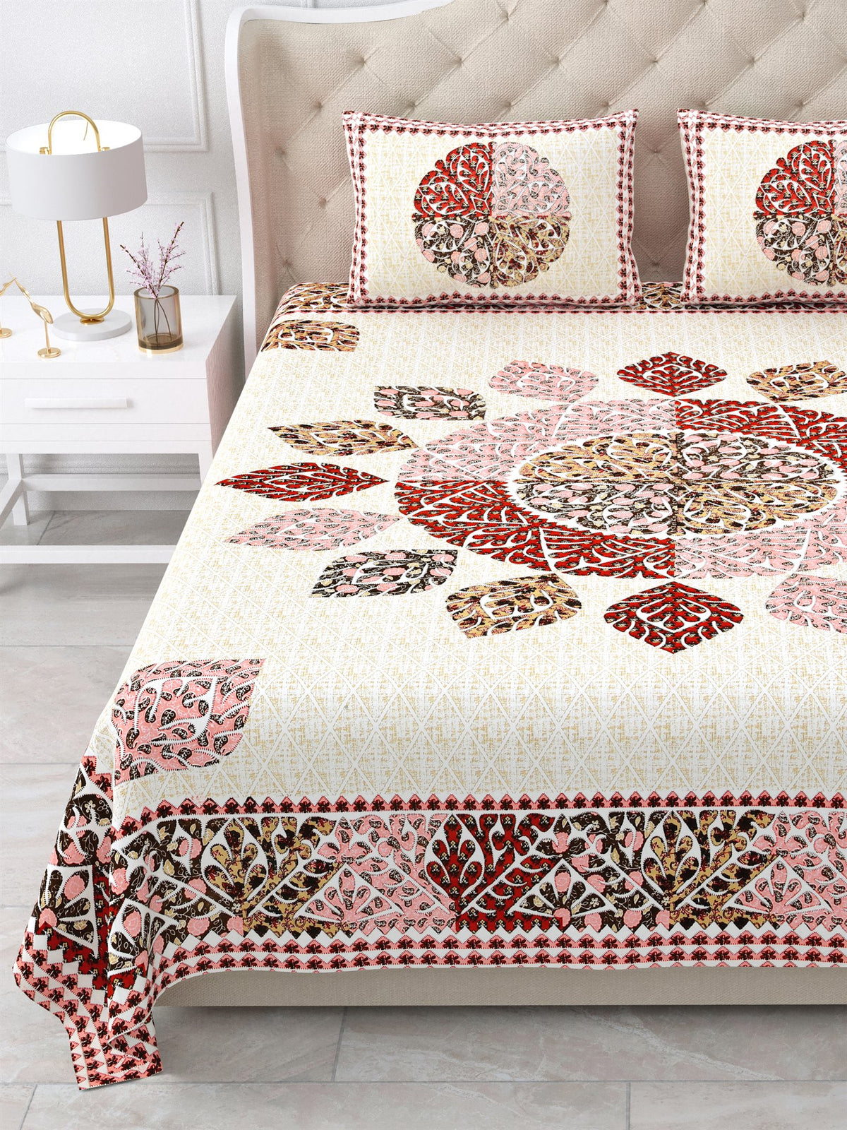 Close view of the maroon, rust and pink leaf mandala and border on the bed