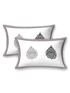 Two white pillow covers with a grey frame and grey & black damask buta motifs