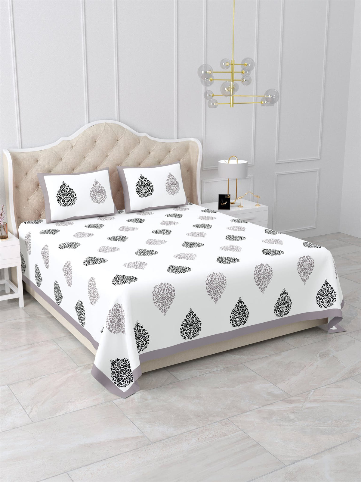 Angled view of the grey & black damask buta bedsheet on a bed with 2 pillow covers