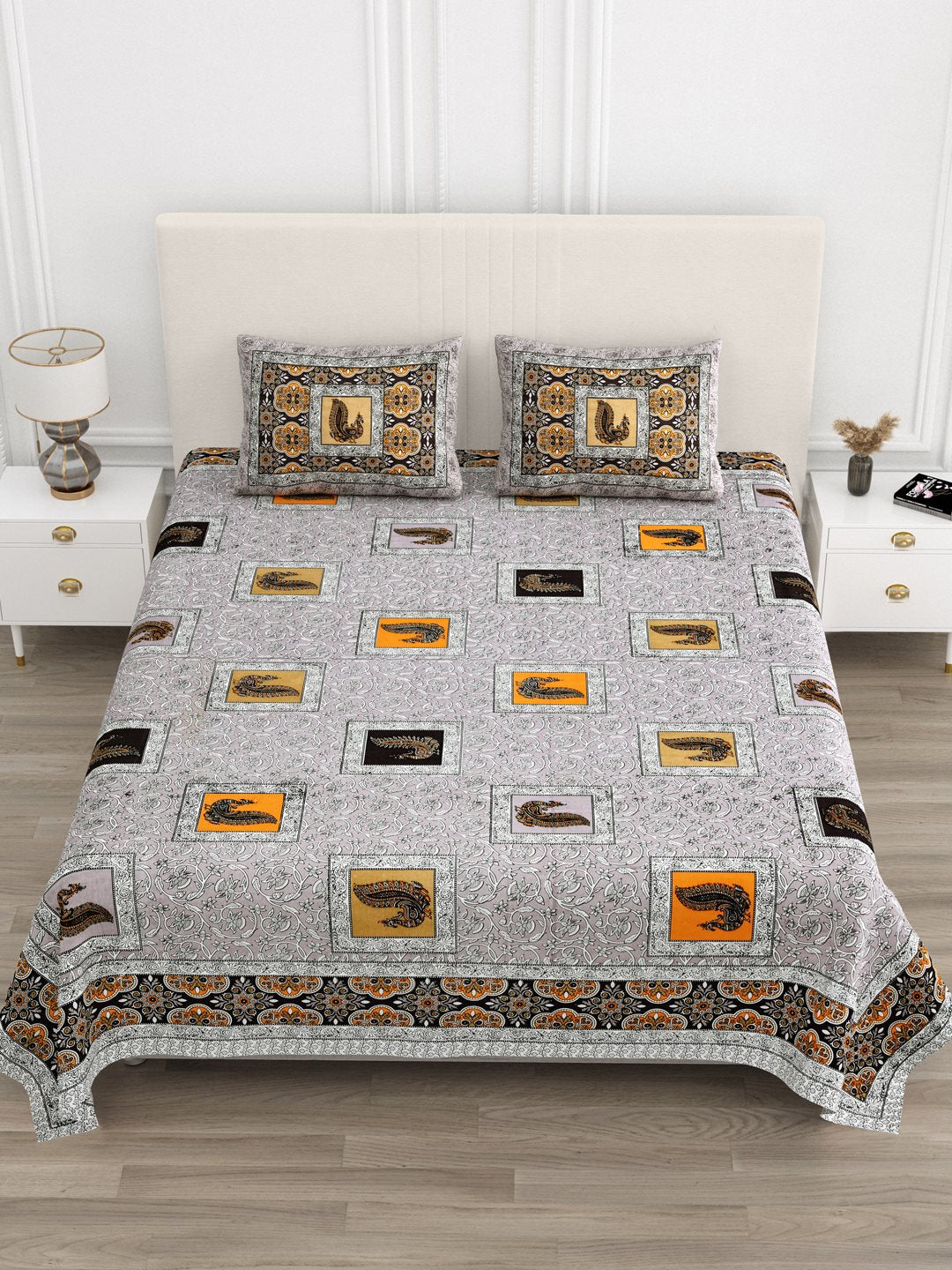 Front view of Castile India grey and orange peacock motif bedsheet 90x108 on a bed with 2 pillow covers