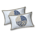 Two white pillow covers with an indigo and beige quartered leaf medallion and triangle-check edge