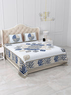 Angled view of the white leaf mandala bedsheet showing the indigo leaf-motif side border