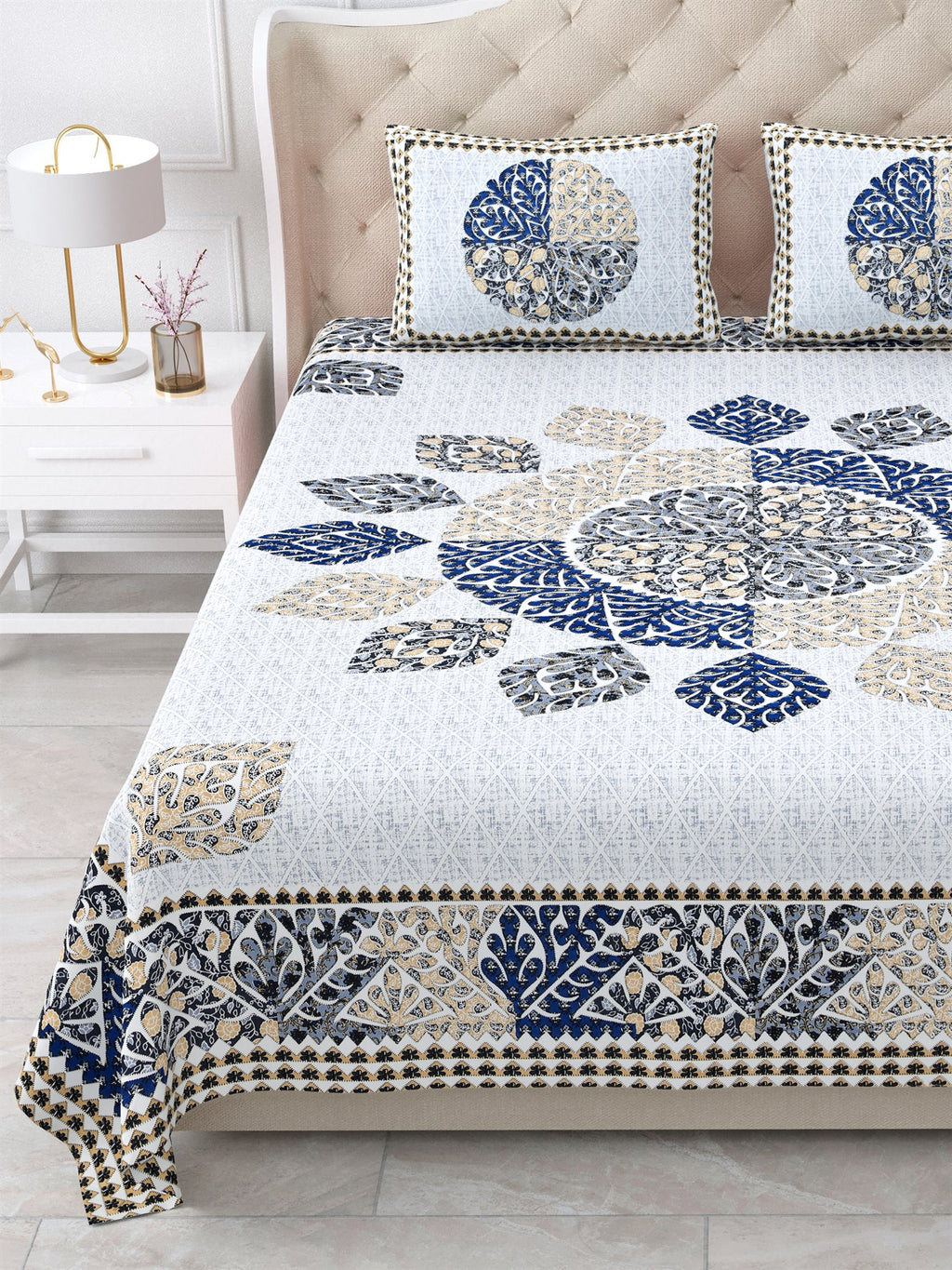 Close view of the indigo and beige leaf mandala and border on the bed