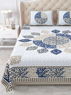 Close view of the indigo and beige leaf mandala and border on the bed