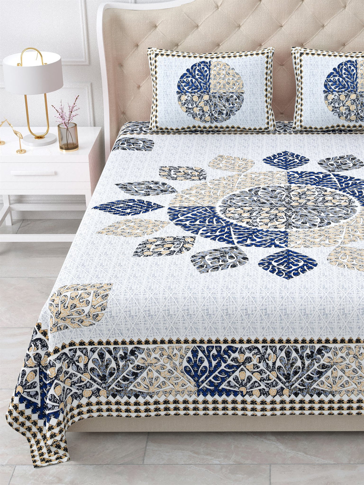Close view of the indigo and beige leaf mandala and border on the bed