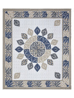 Full flat view of the indigo and beige leaf mandala bedsheet with leaf-motif border