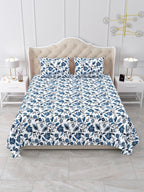 Front view of the indigo blue and white floral vine bedsheet on a bed with 2 matching pillow covers