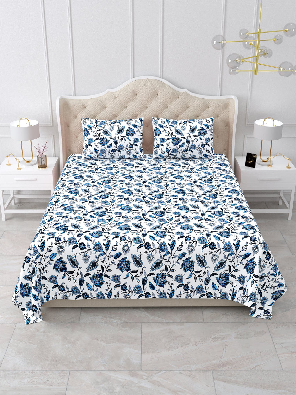 Front view of the indigo blue and white floral vine bedsheet on a bed with 2 matching pillow covers