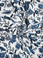 Swirled fabric close-up of indigo, navy and blue floral vines on a white base