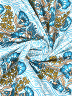 Swirled fabric close-up of blue and olive bouquet motifs on a pale aqua lattice background