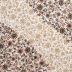 Close-up of maroon and rose-pink flowers meeting soft gold florals on an ivory base