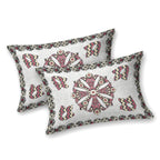 Two off-white pillow covers with a maroon mandala medallion, chevron motifs and a charcoal border