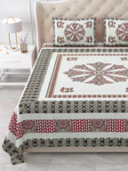 Close view of the maroon mandala centre panel and charcoal and pink borders on the bed