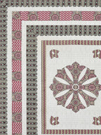 Flat corner close-up of the maroon medallion bedsheet showing charcoal borders and pink panel band