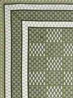 Flat corner view of the olive green bedsheet showing the buta grid and layered borders