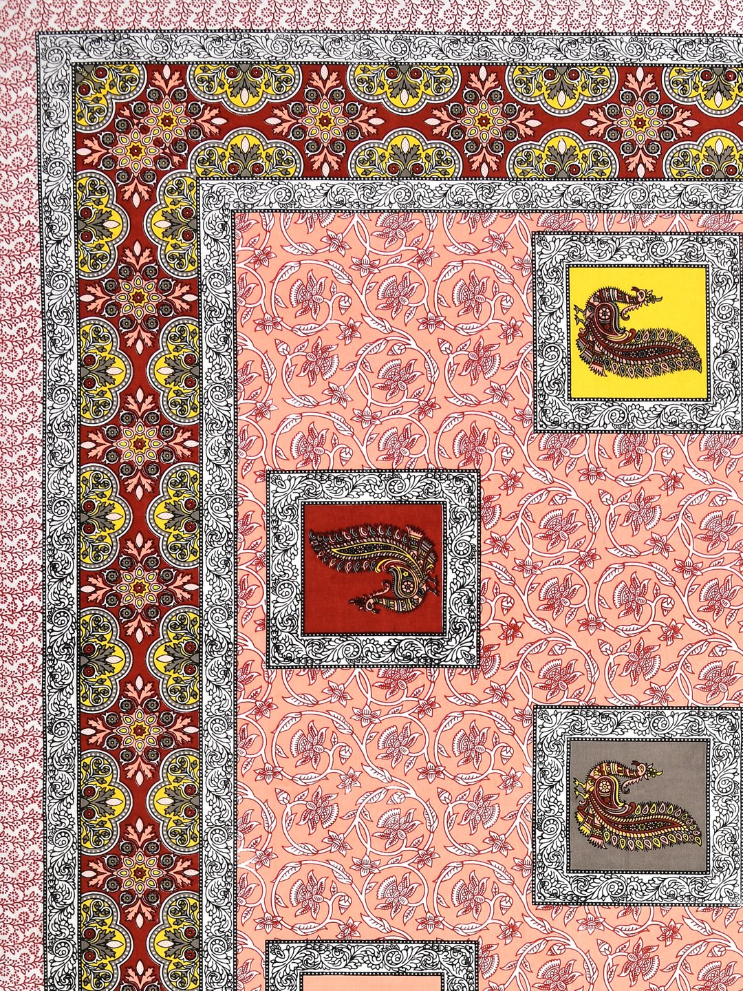 Close-up of yellow, red and grey peacock patches on a peach floral vine background with maroon border