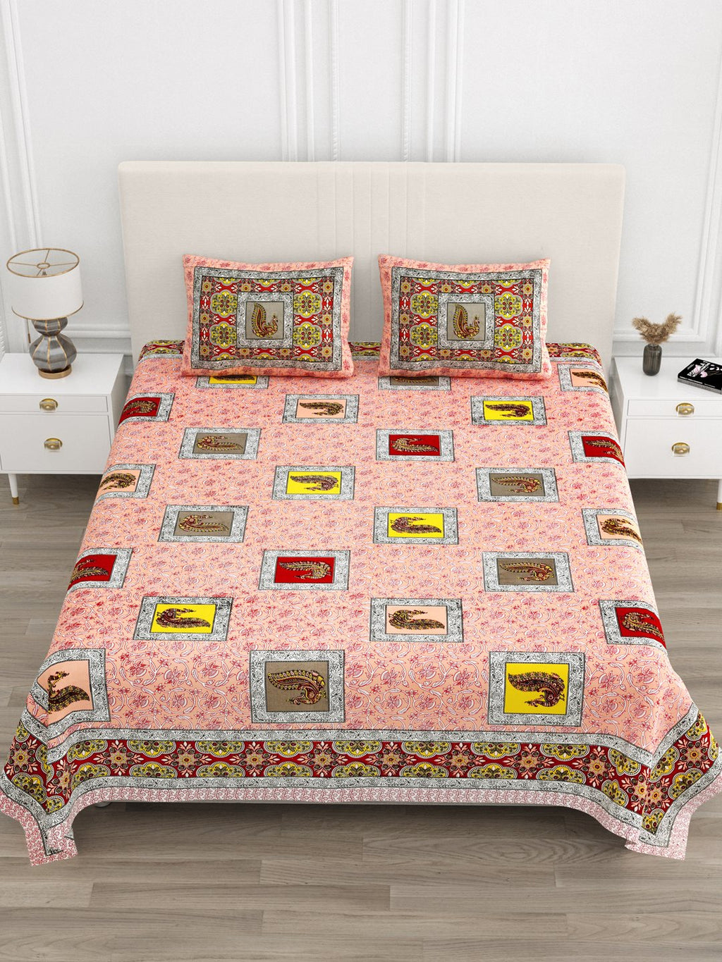 Front view of Castile India peach peacock motif bedsheet 90x108 on a bed with 2 pillow covers