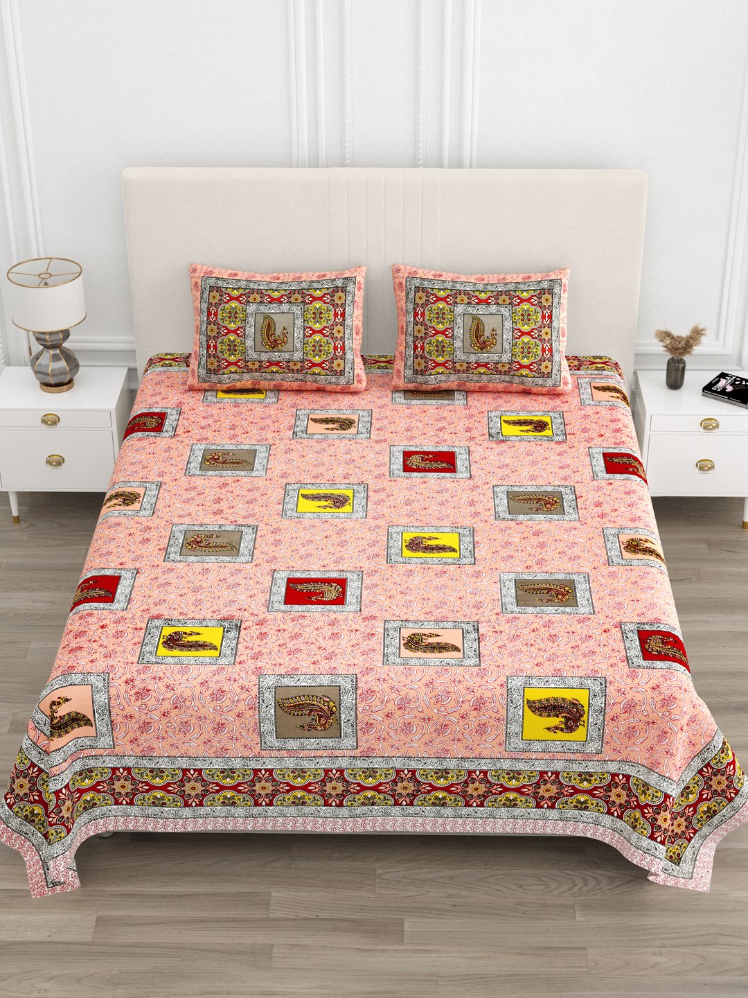 Front view of Castile India peach peacock motif bedsheet 90x108 on a bed with 2 pillow covers