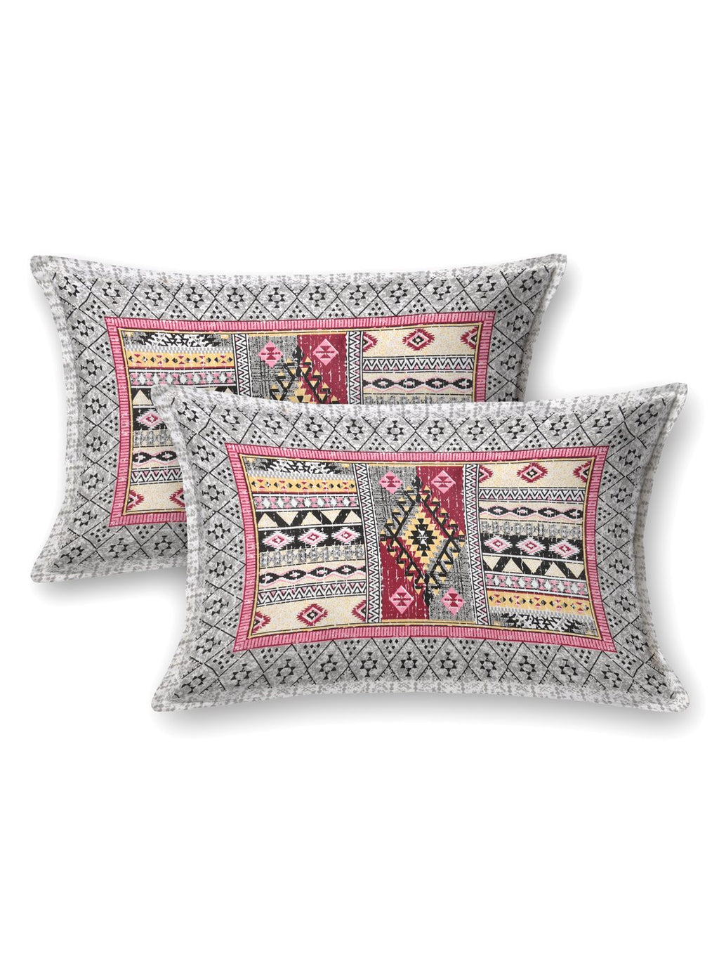 Two pillow covers with a grey geometric border and pink & grey Aztec patchwork centre