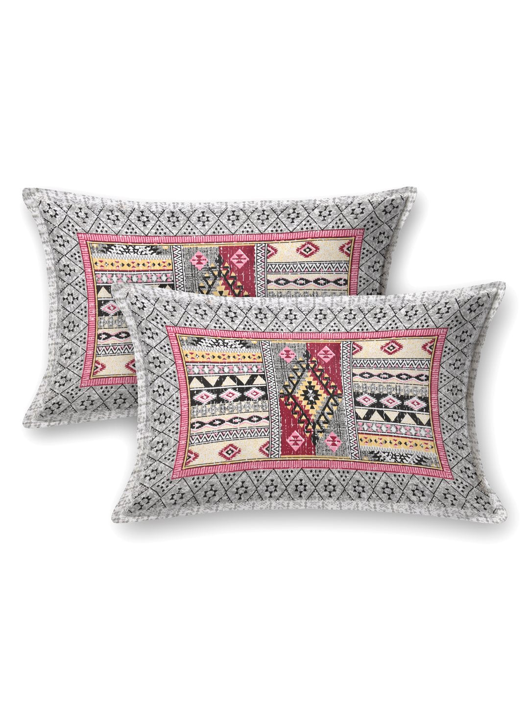 Two pillow covers with a grey geometric border and pink & grey Aztec patchwork centre