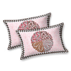 Two pink pillow covers with a maroon, caramel and grey quartered leaf medallion and triangle edge