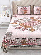 Close view of the maroon, caramel and grey leaf mandala and border on the pink bedsheet
