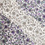 Close-up of purple and lavender blooms meeting taupe-grey florals on a white base