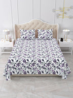 Front view of the purple and white floral vine bedsheet on a bed with 2 matching pillow covers